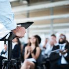A businessman giving a presentation to a group of people.